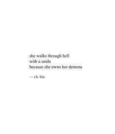 a white wall with a quote on it that says she walks through hell with a smile because she own her demons