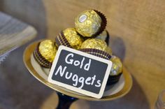 a plate with some chocolates on it and a sign that says gold nuggets