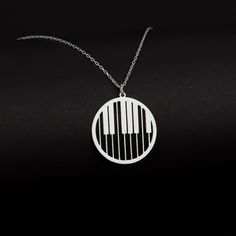 "Piano Keys Necklace in Sterling Silver is made by hand in our workshop with care. All our jewelry is the most elegant choice for the Bridesmaids, friends, your loved ones and for yourself. Piano Keys Necklace in Sterling Silver * Material: High Quality Solid 925 Sterling Silver. * Dimensions: Depending on your font choice, height sizes range from 1,5 mm to 3,5 mm lowercase. * Finish: Sterling Silver ∙ Gold ∙ Rose Gold. HOW TO ORDER ❓ * Select your necklace COLOR. * Choose necklace length from 1 Silver Music-themed Round Jewelry, Piano Jewelry, Piano Necklace, Music-themed Pendant Jewelry As Gift, Music-themed Pendant Necklace As Gift, Silver Music-themed Necklace For Gift, Music-themed Pendant Jewelry Gift, Music-themed Pendant Necklaces As Gift, Music-themed Pendant Jewelry For Gifts