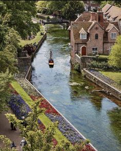 an instagram page with a boat in the water and houses on either side of it