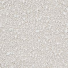 an up close shot of a white carpet textured with small speckles and dots