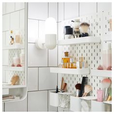 the bathroom shelves are filled with cosmetics and hair products