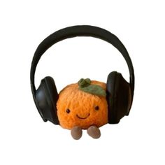 an orange with headphones hanging from it's ear