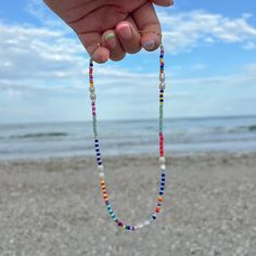 ITEM DESCRIPTION: The Multicolour Beaded Freshwater Pearl Choker Necklace is so dainty and perfect for any occasion! It is made of 3mm glass seed beads and 5-6mm natural freshwater pearls strung on beading thread! The necklace is 14 inches long with a 2 inch extender chain (16 inches total) This is are perfect for layering with other necklaces from my shop! SHIPPING: Estimated delivery timelines can be found under delivery and return policies **Please note that to offer low shipping costs, this Multicolor Pearl Necklace With Colorful Beads For Beach, Rainbow Pearl Beaded Necklaces, Rainbow Beaded Pearl Necklace With Round Beads, Summer Multicolor Beaded Pearl Necklace, Multicolor Beaded Pearl Necklace For Summer, Beach Pearl Beaded Necklaces With Colorful Beads, Multicolor Beaded Pearl Necklace For Beach, Beach Pearl Beaded Necklaces With Spacer Beads, Pearl Beaded Necklaces With Spacer Beads For Beach