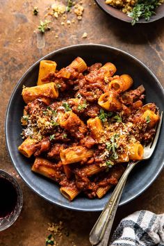 a bowl filled with pasta and sauce on top of a table