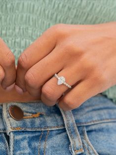 a close up of a person's hand with a ring on their finger,