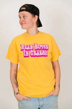 "Head Butch In Charge" screen-printed yellow shirt. Let everyone know who is really in charge with this fun shirt. Pre-shrunk, soft washed, garment dyed fabric Designed and made in New Orleans Unisex sizing Size Chart: (in inches) S M L XL 2XL 3XL Sleeve Length 8 8 ¼ 9 9 ½ 9 ¾ 9 ¾ Full Body Length 27 28 ½ 30 31 ½ 32 ¾ 33 Body Width 18 ½ 20 ½ 22 ½ 24 ½ 26 ½ 28 Fitted Yellow T-shirt With Graphic Print, Yellow Crew Neck Top With Funny Text, Yellow Relaxed Fit Pre-shrunk T-shirt, Funny Yellow Tops With Letter Print, Funny Yellow Top With Letter Print, Unisex Yellow Graphic Print Top, Yellow Crew Neck T-shirt With Funny Text, Yellow Casual Tops With Funny Text, Yellow Graphic Tee Shirt With Screen Print