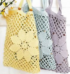 three crocheted bags hanging on a hook