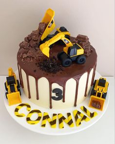 a birthday cake with construction vehicles on top