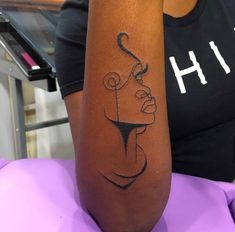 a woman with a tattoo on her arm