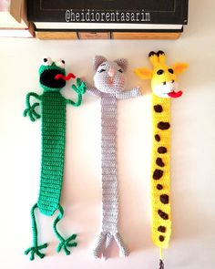 three crocheted animals are hanging on the wall next to a sign that says chedigreenstrainn