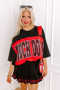 - Show off your team spirit in this dazzling oversized 'TOUCHDOWN' tee! Featuring a sequined design and chic unfinished seam accents, you'll shine on game day. Get the Game Day essentials for the Arkansas Razorbacks, Arkansas State Red Wolves, Texas A&M Aggies, Texas Tech Red Raiders, or the University of Georgia Bulldogs teams. - Unlined lightweight material with unfinished seam accents - A sequined 'TOUCHDOWN' design across the front - Short drop sleeves - An oversized silhouette that ends in Black Collegiate T-shirt For Fall, Black Varsity T-shirt For Fall, Trendy Black Tops For Game Day, Casual Tops With Glitter Print For Streetwear, Varsity Style Black Tops With Text Print, Casual Black Tops With Glitter Print, Oversized Black Tops For College, Oversized Black College Style Top, Black T-shirt For Game Day In Fall