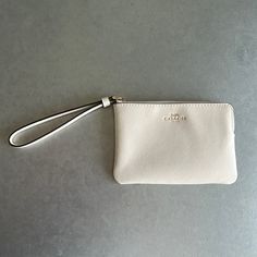 Coach White Wristlet Wallet, New With Tags Inside! Chic On-the-go Wristlet Clutch, Chic Beige Wallet With Zipper Pouch, Classic Rectangular Wristlet For Everyday, Classic Everyday Rectangular Wristlet, Elegant Cream Bag With Wrist Strap, Cream Pouch Wallet For Everyday Use, Classic Cream Clutch For Everyday Use, Elegant Coach Pouch For Everyday, Chic Wristlet With Zipper Pouch