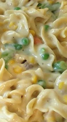 a close up view of some noodles and peas