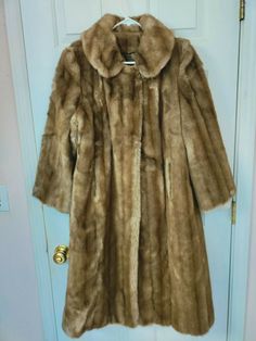 New with tags (NOS). Mink fur coat style and look, vintage faux fur. Single button at top, collar. No size tag, appearing to be a small. See measurements. Has original store tag $240 from J. C. Penney. Made in USA. **See measurements below for a good fit. MEASUREMENTS: Armpit to armpit laid flat 20". Shoulder to cuff end 21". Back center neckline to hem edge 41". Fast Shipping to USA. USPS Priority Mail. 1092005 Classic Faux Fur Coat With Fur Trim, Formal Faux Fur Outerwear In Mink Color, Formal Mink Outerwear With Faux Fur Lining, Classic Fitted Faux Fur Coat, Vintage Fur Coat With Faux Fur Trim, Vintage Faux Fur Mink Coat, Vintage Formal Fur Coat With Faux Fur Trim, Vintage Fur Coat For Winter Formal, Vintage Fur Coat For Winter Formal Occasions