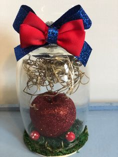 a glass jar filled with red, white and blue ornaments