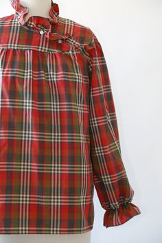 "Vintage 1970s Fall plaid blouse High neck ruffle neck + puff ruffle sleeves Great vintage condition M e a s u r e m e n t s: Size: fits like a M L BUST: 23\" Waist: 24\" Total length: 27 1/2\" Sleeves: 23\" Label: Lucky winner +All Measurements are taking while garment is lying flat+ + Jewelry, belts, and any other accessories are NOT included unless specifically stated in description+ i n s t a g r a m: cali_vintage_usa" Plaid Long Sleeve Blouse With Ruffles, Fall Plaid Top With Ruffles, Fall Plaid Ruffled Tops, Fall Daywear Plaid Blouse, Plaid Blouse For Daywear In Fall, Retro Puff Sleeve Tops For Fall, Vintage Plaid Blouse For Fall, Retro Ruffled Blouse For Fall, Retro Blouse For Fall