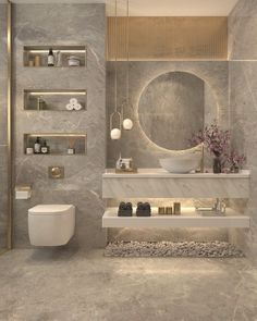 a bathroom with marble walls and flooring is shown in this image, there are shelves on either side of the toilet