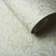 an image of a roll of wallpaper with flowers and leaves on the back side