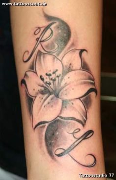 a tattoo on the arm of a woman with flowers