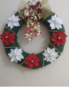 a green wreath with red and white poinsettis