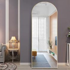 a living room filled with furniture and a large mirror in the middle of it's wall