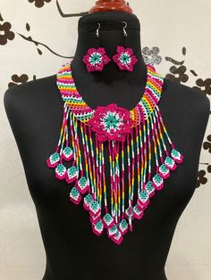 This beautiful Huichol jewelry set is the perfect complement to add style and color to your Mexican outfit, made entirely by hand by Huichol artisans from the state of Nayarit in Mexico. This choker is a piece with a compound made by Huichol artisans, made entirely by hand, unique pieces, very colorful boho type, for any occasion. The Huichol artisans base all their works and their designs on visions they have during their sacred rituals proper to their ethnicity, The Huicholes inhabit the state Traditional Handmade Pink Beads, Traditional Handwoven Choker Jewelry, Traditional Multicolor Fair Trade Jewelry, Multicolor Handwoven Jewelry For Festivals, Traditional Multicolor Handwoven Choker, Adjustable Multicolor Jewelry Sets For Festivals, Traditional Multicolor Beaded Jewelry Sets, Handmade Pink Beaded Necklaces For Festivals, Multicolor Beaded Jewelry For Fiesta