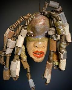 a sculpture made out of various objects including wires and plastic headdress, which are attached to each other