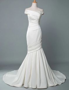 a white wedding dress on a mannequin