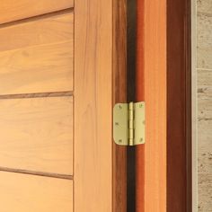 a close up of a door handle on a wooden door