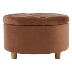 a brown ottoman sitting on top of a wooden table