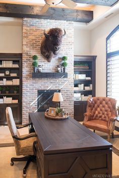 a living room filled with furniture and a fire place next to a brick wall in front of a fireplace