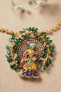 Gold toned Radha Krishna long pendant necklace with stones, crystals and Moissanite embellishments. - Aza Fashions Diamond Pendant Necklace In Temple Jewelry Style, Fusion Style Diamond Pendant Jewelry, Green Diamond Temple Jewelry Necklace, Diamond Emerald Pendant Necklace, Exquisite Hand Set Pendant Necklace, Diamond Pendant Necklace In Fusion Style, Temple Jewelry Pendant With Stones, Diamond Pendant Fusion Necklace, Fusion Style Diamond Pendant Necklace