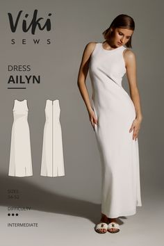 a woman in a white dress and sandals standing next to an item from the viki sewing pattern