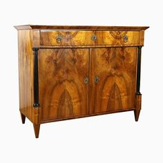 an antique wooden cabinet with metal handles