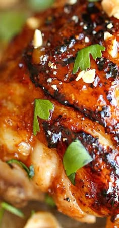 a close up view of some meat with herbs on it's side and garnished with green leaves