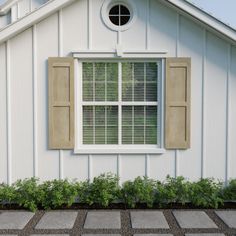 a white house with black shutters and windows