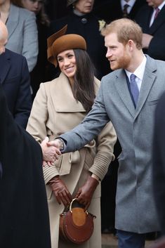 two people shaking hands in front of an instagram page with the caption, prince harry and princess charlotte