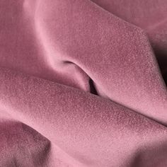 a close up view of a pink fabric with very soft, textured folds on it