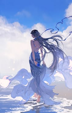 a woman with long hair standing in the water