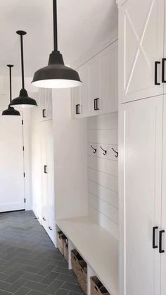 a kitchen with white cabinets and black lights