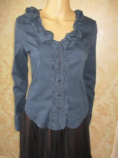 Black long sleeved shirt with a ruffled neck line and  button band.  The back is stretchy and the front cotton.  It has buttons to close and buttons on the cuffs. Bust pit to pit flat;  19" Length;  22" Inside arm;  19" Made by PORTO FORTUNA Fitted Tops With Ruffles And Ruffled Collar, Chic Long Sleeve Ruffled Shirt, Fall Cotton Collared Blouse, Fall Cotton Blouse With Collar, Fall Cotton Blouse, Cotton Button-up Tops With Ruffles, Stretch Cotton Button-up Blouse, Casual Shirt With Ruffled Collar For Fall, Cotton Ruffle Button-up Tops