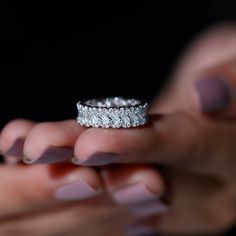 a woman holding a diamond ring in her hand