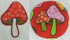 two colorful mushrooms with hearts on them sitting next to each other