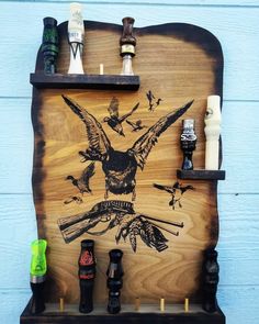 a wooden shelf with bottles and other items on it's sides, including an image of a bird