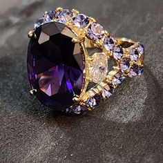 Large Purple Statement Ring, Amethyst CZ Gold Ring, AAA Grade CZ, Womens Ring Chunky ==  ABOUT THIS RING == * Condition: NEW * Metal: Steel * Finish: Gold plating * Stamp: no stamp * CZ Quality: AAA * CZ Color: Purple * Front of ring Amethyst CZ size: 17x12mm * Back of ring band width: 2.5mm * Band features: Heart cut-out tall setting For size reference, a quarter is 25mm and a nickel is 21mm Beautiful statement ring. Large faux Amethyst single CZ. AAA High quality.  Amethyst is the birthstone f Purple Ring With Large Stone, Large Amethyst Ring, Luxury Purple Crystal Ring For Women, Purple Jewelry Ring With Large Stone, Purple Amethyst Multi-stone Crystal Ring, Purple Ring, February Birthday, Womens Ring, New Metal