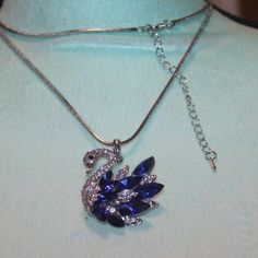 Nwt: Birds: Clear & Blue Rhinestone Swan Necklace, He Is 2" Tall, He Is On A Silver Tone 28" Chain With A Lobster Clasp Blue Crystal Necklaces With Bling, Blue Rhinestone Necklace For Party, Swan Necklace, Bird Jewelry, Blue Rhinestones, Blue And Silver, Womens Jewelry Necklace, Lobster Clasp, Silver Tone