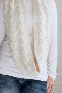 This cable infinity scarf knitting pattern is knit flat, using 2 straight needles with bulky yarn, so it knits up relatively quick! Wrap yourself in warmth and style with this versatile piece that combines the comfort of a scarf with the snug fit of a cowl. It's perfect for layering for fall & winter wear! Rib Knit Scarf, Infinity Scarf Knitting Pattern, Scoop Sweaters, Knit Purl Stitches, Scarf Knitting Pattern, Cable Scarf, Sweater Pin, Scarf Knitting