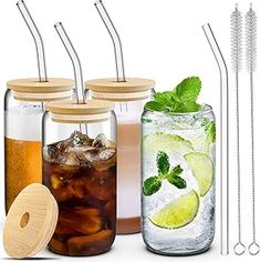 four mason jars with drinking straws and two glasses filled with drinks