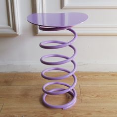 a purple table sitting on top of a hard wood floor